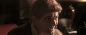 Movie still from “JFK” (1991), directed by Oliver Stone – A person wearing a sweater; Close Up shot, Over the shoulder angle