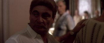 Movie still from “JFK” (1991), directed by Oliver Stone – An older man is looking at the camera; Close Up shot, Over the shoulder angle