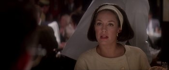 Movie still from “JFK” (1991), directed by Oliver Stone – A person holding an umbrella; Close Up shot, Over the shoulder angle