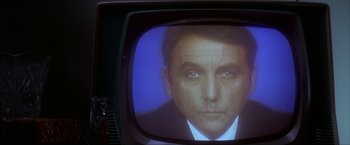 Movie still from “JFK” (1991), directed by Oliver Stone – A man's face on a television screen; Extreme Close Up shot, Low angle