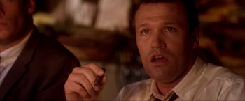 Movie still from “JFK” (1991), directed by Oliver Stone – A person holding a pen; Close Up shot, Low angle