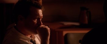 Movie still from “JFK” (1991), directed by Oliver Stone – A person with his hand on his chin; Close Up shot, Over the shoulder angle