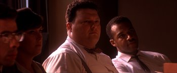 Movie still from “JFK” (1991), directed by Oliver Stone – A man in a bow tie is looking at the camera; Close Up shot, Low angle