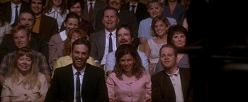 Movie still from “JFK” (1991), directed by Oliver Stone – A group of men and women sitting in front of each other; Medium shot, Over the shoulder angle
