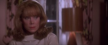 Movie still from “JFK” (1991), directed by Oliver Stone – A person wearing a white shirt; Close Up shot, Over the shoulder angle