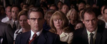 Movie still from “JFK” (1991), directed by Oliver Stone – A group of people sitting in a room; Close Up shot, Low angle