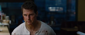 Movie still from “Jack Reacher: Never Go Back” (2016), directed by Edward Zwick – A man in a white shirt with blood all over his face; Close Up shot, Over the shoulder angle