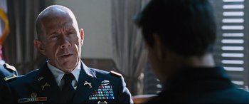 Movie still from “Jack Reacher: Never Go Back” (2016), directed by Edward Zwick – A man in a military uniform talking to another man; Close Up shot, Over the shoulder angle