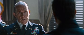 Movie still from “Jack Reacher: Never Go Back” (2016), directed by Edward Zwick – An older man in a military uniform talking to a younger man; Close Up shot, Over the shoulder angle