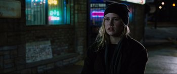 Movie still from “Jack Reacher: Never Go Back” (2016), directed by Edward Zwick – A young woman wearing a black hat and a black jacket; Close Up shot, Over the shoulder angle