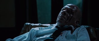 Movie still from “Jack Reacher: Never Go Back” (2016), directed by Edward Zwick – An old man with a tie on laying on a couch; Close Up shot, Low angle