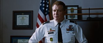 Movie still from “Jack Reacher: Never Go Back” (2016), directed by Edward Zwick – A person wearing a uniform; Medium shot, Low angle