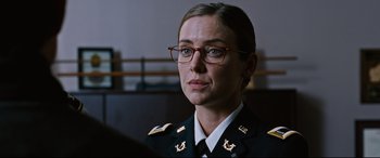 Movie still from “Jack Reacher: Never Go Back” (2016), directed by Edward Zwick – A woman in a military uniform wearing glasses; Close Up shot, Over the shoulder angle