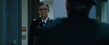 Movie still from “Jack Reacher: Never Go Back” (2016), directed by Edward Zwick – A woman in a military uniform looking at a mirror; Close Up shot, Over the shoulder angle
