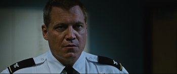 Movie still from “Jack Reacher: Never Go Back” (2016), directed by Edward Zwick – A person wearing a police uniform; Close Up shot, Low angle