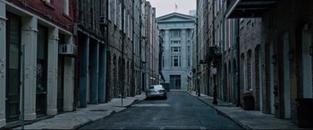 Movie still from “Jack Reacher: Never Go Back” (2016), directed by Edward Zwick – A car is parked on the side of the street; Extreme Wide shot, High angle