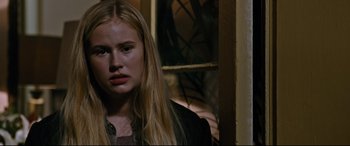 Movie still from “Jack Reacher: Never Go Back” (2016), directed by Edward Zwick – A young blonde woman with long blonde hair looking at the camera; Close Up shot, Over the shoulder angle