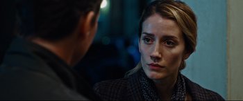 Movie still from “Jack Reacher: Never Go Back” (2016), directed by Edward Zwick – A woman looking at another woman in a dark room; Close Up shot, Over the shoulder angle