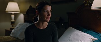 Movie still from “Jack Reacher: Never Go Back” (2016), directed by Edward Zwick – A woman sitting in front of a bed in a dark room; Close Up shot, Over the shoulder angle