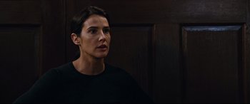 Movie still from “Jack Reacher: Never Go Back” (2016), directed by Edward Zwick – A woman in a black shirt looking to her left; Close Up shot, Over the shoulder angle