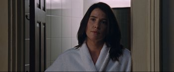Movie still from “Jack Reacher: Never Go Back” (2016), directed by Edward Zwick – A woman wearing a white robe in a bathroom; Close Up shot, Over the shoulder angle