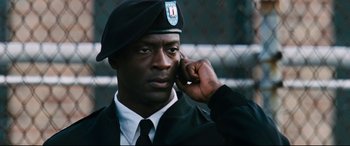 Movie still from “Jack Reacher: Never Go Back” (2016), directed by Edward Zwick – A man in a uniform talking on a cell phone; Close Up shot, Low angle