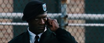 Movie still from “Jack Reacher: Never Go Back” (2016), directed by Edward Zwick – A man in a military uniform talking on a cell phone; Close Up shot, High angle