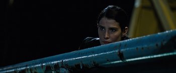 Movie still from “Jack Reacher: Never Go Back” (2016), directed by Edward Zwick – A woman looking over a railing at night; Close Up shot, Over the shoulder angle