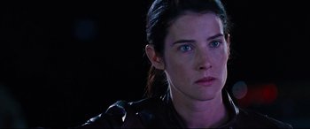 Movie still from “Jack Reacher: Never Go Back” (2016), directed by Edward Zwick – A woman that is looking at the camera; Close Up shot, Over the shoulder angle