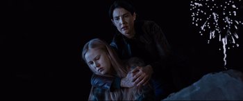 Movie still from “Jack Reacher: Never Go Back” (2016), directed by Edward Zwick – A woman and a child are sitting on the ground; Medium shot, Low angle