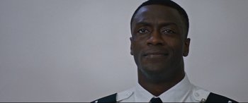 Movie still from “Jack Reacher: Never Go Back” (2016), directed by Edward Zwick – A person wearing a police uniform; Close Up shot, Low angle