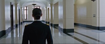 Movie still from “Jack Reacher: Never Go Back” (2016), directed by Edward Zwick – A woman in a uniform is walking down a hall way; Wide shot, Over the shoulder angle