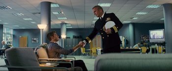 Movie still from “Jack Ryan: Shadow Recruit” (2014), directed by Kenneth Branagh – Two men shaking hands in an office setting; Medium shot, Over the shoulder angle
