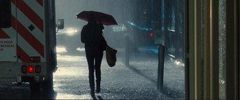 Movie still from “Jack Ryan: Shadow Recruit” (2014), directed by Kenneth Branagh – A person walking down a street holding an umbrella; Wide shot, Low angle