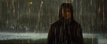 Movie still from “Jack Ryan: Shadow Recruit” (2014), directed by Kenneth Branagh – A man in a hooded jacket standing in the pouring rain; Medium shot, Over the shoulder angle