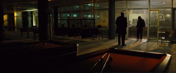 Movie still from “Jack Ryan: Shadow Recruit” (2014), directed by Kenneth Branagh – A man standing in front of a pool table; Wide shot, Over the shoulder angle