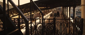 Movie still from “Jack Ryan: Shadow Recruit” (2014), directed by Kenneth Branagh – A person walking down a ramp on a bridge; Extreme Wide shot, Low angle