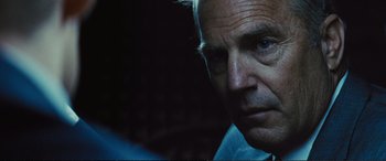 Movie still from “Jack Ryan: Shadow Recruit” (2014), directed by Kenneth Branagh – A man's face in the dark; Close Up shot, Over the shoulder angle