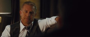 Movie still from “Jack Ryan: Shadow Recruit” (2014), directed by Kenneth Branagh – A person wearing a suit and tie; Close Up shot, Over the shoulder angle