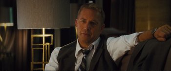 Movie still from “Jack Ryan: Shadow Recruit” (2014), directed by Kenneth Branagh – A person wearing a suit and tie; Close Up shot, Over the shoulder angle