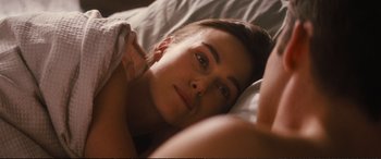 Movie still from “Jack Ryan: Shadow Recruit” (2014), directed by Kenneth Branagh – A woman laying in a bed with her head on her pillow; Close Up shot, Over the shoulder angle