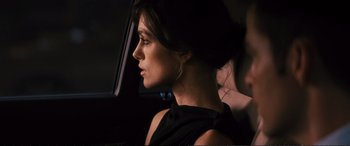 Movie still from “Jack Ryan: Shadow Recruit” (2014), directed by Kenneth Branagh – A woman in a black dress sitting in a car; Close Up shot, Over the shoulder angle