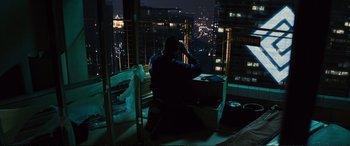 Movie still from “Jack Ryan: Shadow Recruit” (2014), directed by Kenneth Branagh – A man sitting on top of a chair looking out a window; Wide shot, High angle