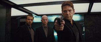 Movie still from “Jack Ryan: Shadow Recruit” (2014), directed by Kenneth Branagh – A group of men standing next to each other holding a gun; Medium shot, Low angle