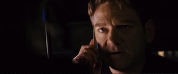 Movie still from “Jack Ryan: Shadow Recruit” (2014), directed by Kenneth Branagh – A person talking on a cell phone; Close Up shot, Low angle