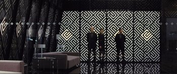 Movie still from “Jack Ryan: Shadow Recruit” (2014), directed by Kenneth Branagh – Two people are standing in front of a mirror; Wide shot, Low angle