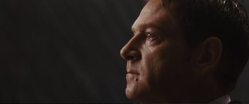 Movie still from “Jack Ryan: Shadow Recruit” (2014), directed by Kenneth Branagh – A man's face in a dark room; Close Up shot, Low angle