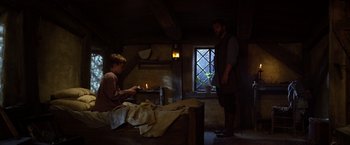 Movie still from “Jack the Giant Slayer” (2013), directed by Bryan Singer – A man standing next to a woman in a room; Wide shot, Low angle