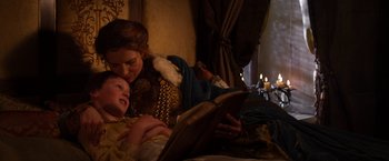 Movie still from “Jack the Giant Slayer” (2013), directed by Bryan Singer – A woman and a little girl are reading a book; Medium shot, High angle