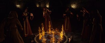 Movie still from “Jack the Giant Slayer” (2013), directed by Bryan Singer – A group of people standing in front of a fire pit; Wide shot, High angle